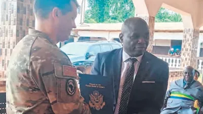 Geste symbolique de réception entre l’attaché de Défense américain, Christopher Plume et le DG de Bongolo, Rev. pasteur Benjamin Kombo