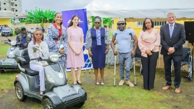 Les officiels ont posé avec une des bénéficiaires de scooters.